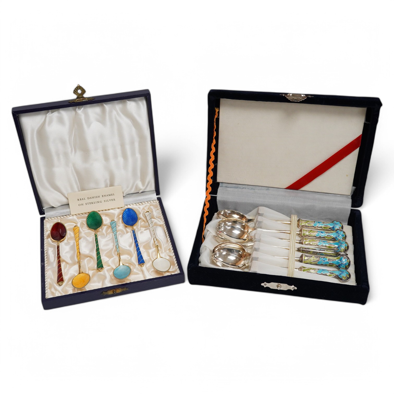 A mid 20th century cased set of six Danish gilt sterling and polychrome enamel coffee spoons, by Egon Lauridson, 94mm, together with one other set of six white metal and enamelled teaspoons, stamped 'silver'. Condition -